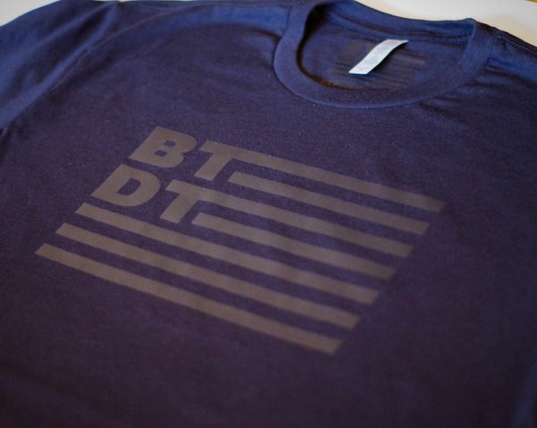 Black on black men's T-shirt with our subdued flag logo across the entire chest. Let others know you've been there, done that!