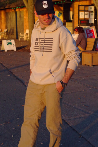 Tan hooded sweatshirt with our flag logo across the entire chest. Let others know you've been there, done that!